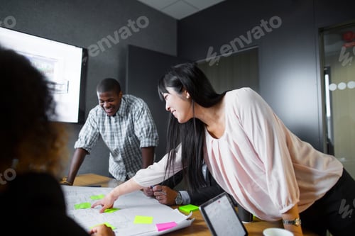 Preview: Team members engaged in a lively discussion over paperwork