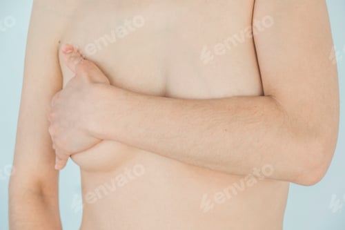 Preview: The woman covers her chest with her hand.