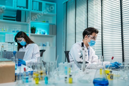 Preview: Asian male and female scientis work together in the research laboratory.