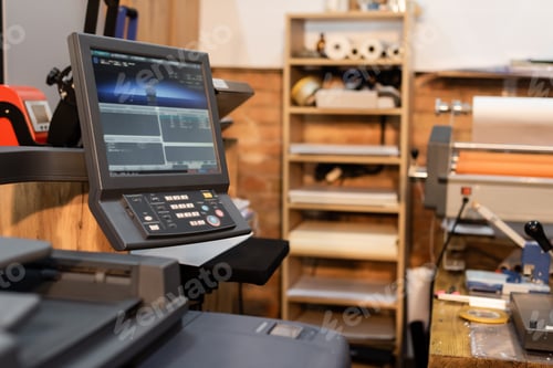 Preview: modern printer next to monitor and button panel in print center