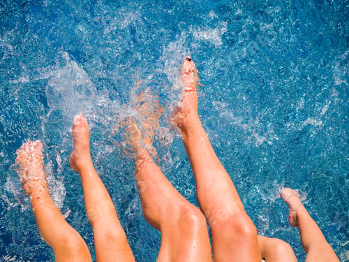 Preview: Close-up of feet of family in the pool