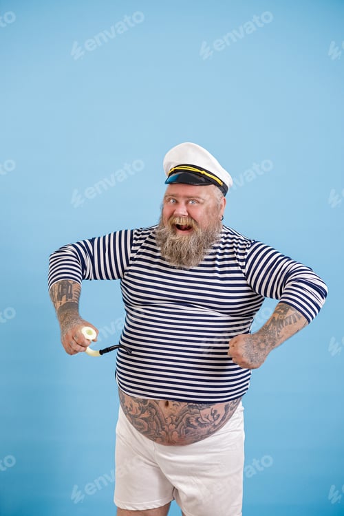 Preview: Dashing plus size person wearing sailor costume with pipe poses on light blue background