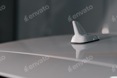 Preview: car antenna on a glossy white roof of a modern car