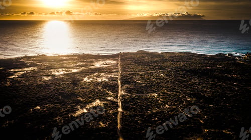 Preview: Aerial view of clear line path road on the outdoor nature to the ocean with golden sunset