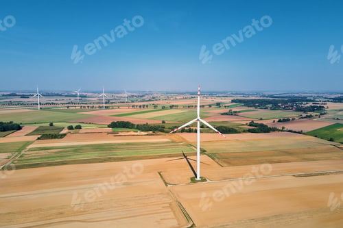Preview: Windmill turbine in the field at summer day. Rotating wind generator