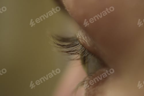 Preview: Selective shot of an eye with beautiful long eyelashes on the blurred background