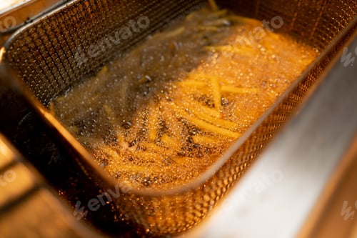 Preview: professional cuisine in the hotel restaurant french fries fried in hot oil in deep fryer close-up