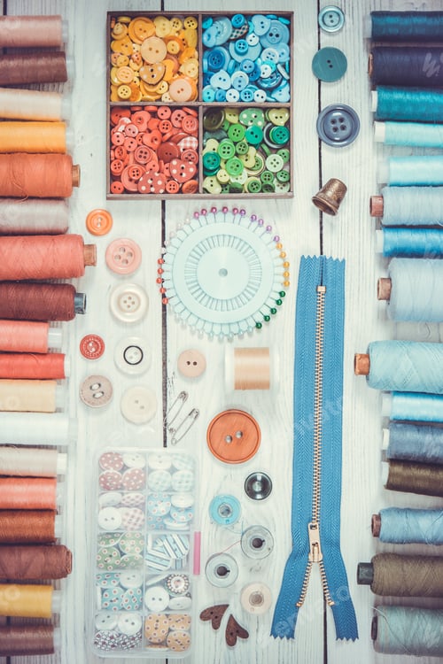 Preview: Tools and accessories for sewing on light wooden background.