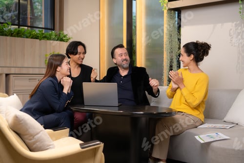 Preview: Group of business people discussing business plan at meeting table in office.