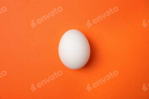 Preview: Raw chicken egg on color background, top view