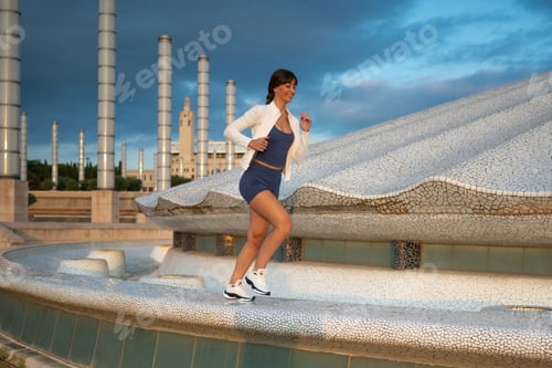 Preview: Woman running in Anella Olímpica Barcelona cityscape