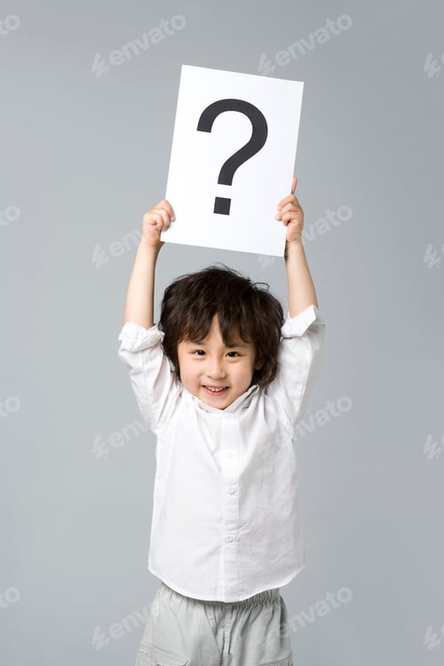 Preview: Little boy holding a sign with a question mark