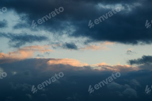 Preview: Blue sky during the day. The weather is bad. Fluffy clouds. Light breaks through the clouds.