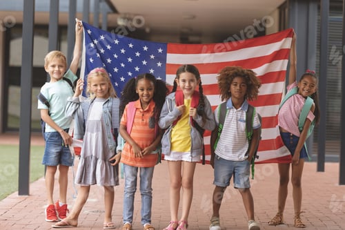 Preview: School students standing in outside corridor at school while holding american flag