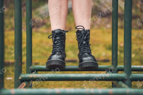 Preview: Person with boots on park swing