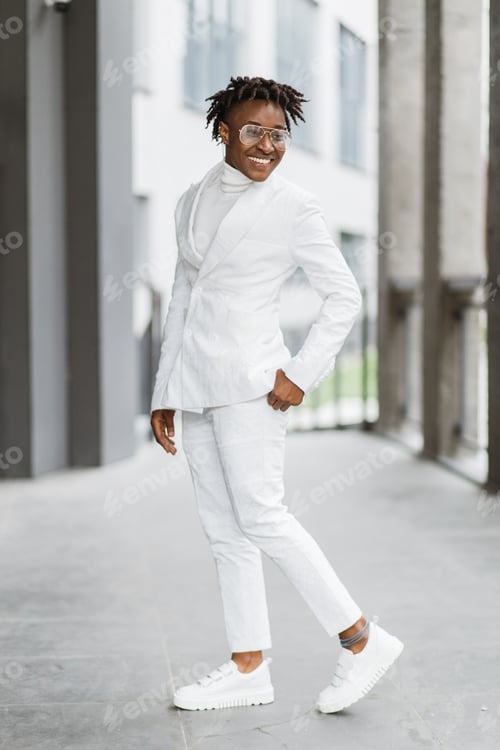 Preview: Beautiful confident fashionable African lady, posing near a modern shopping mall.