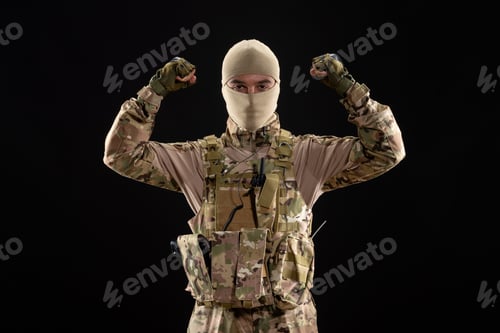 Preview: front view of young soldier in uniform and mask on black background palestine warrior tank
