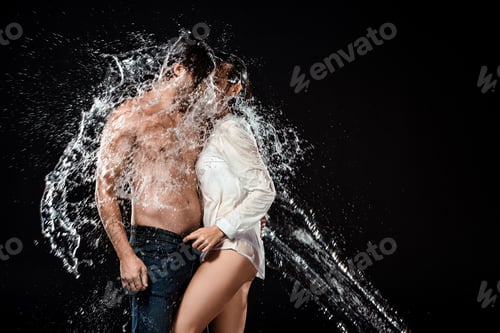 Preview: side view of seductive couple with water splash isolated on black