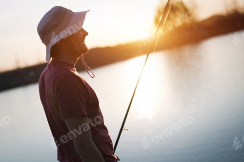 Preview: Men fishing in sunset and relaxing while enjoying hobby