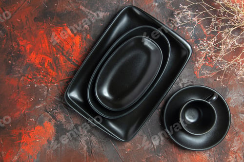 Preview: top view black oval and rectangular platters black cup and saucer on dark red background
