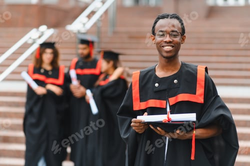 Preview: Smiling graduate student holding diploma and cap