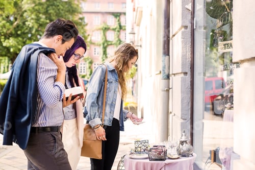 Preview: Friends selecting crockery outside store