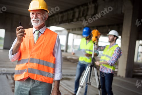 Preview: Engineer, foreman and worker discussing in building construction site