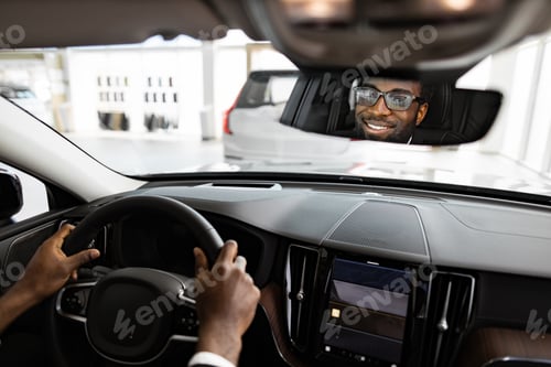 Preview: Happy businessman buying new car at dealership