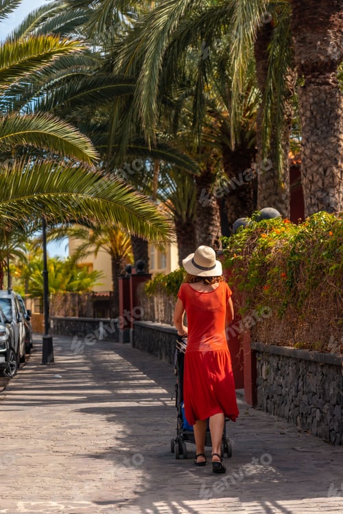 Preview: Tourist woman walking along the promenade through the town of Valle Gran Rey on La Gomera, Canary
