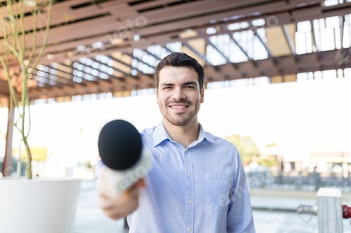 Preview: Broadcaster Holding Mic For Interview