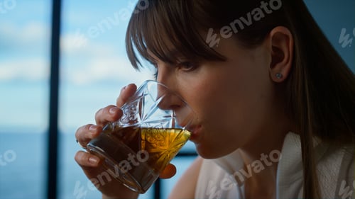 Preview: Office manager drinking whiskey closeup. Tired businesswoman working holding