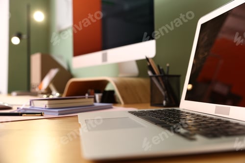 Preview: Stylish workplace with modern computer, laptop and stationery on wooden desk indoors, closeup