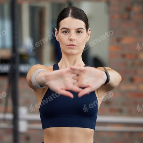 Preview: Fitness, athlete and woman doing a stretching exercise before an intense workout in gym. Sports, tr