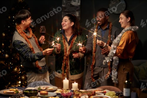 Preview: Cheerful People Holding Bengal Lights while Celebrating Christmas at Home