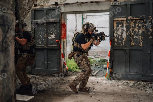Preview: Full length of air soft player with sniper going in action and battle
