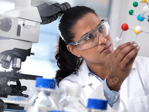Preview: female scientist examining chemical formula