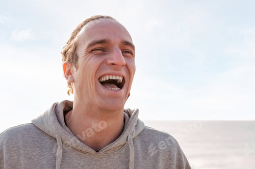 Preview: portrait of a young caucasian man laughing happy