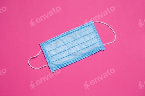 Preview: Blue medical surgical mask for protection against the virus on a colored background