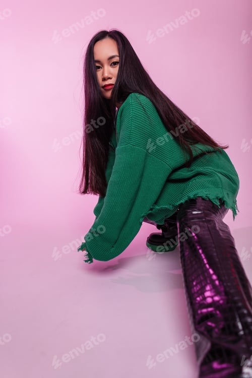 Preview: Beautiful asian fashion girl in stylish knitted ripped green sweater