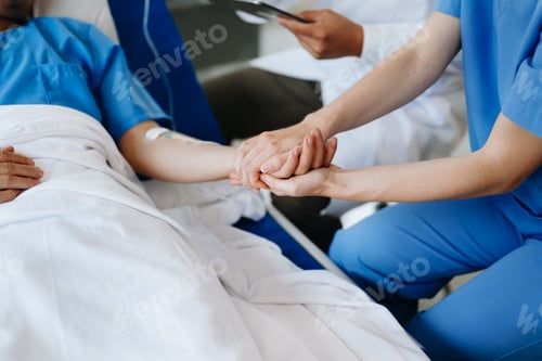 Preview: Female doctor holding male patient hand on the bed with receiving saline solution in hospital