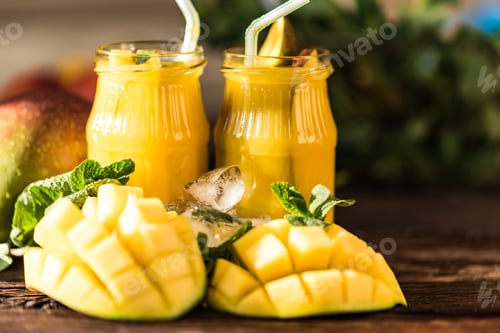 Preview: Mango juice and mango on wood table