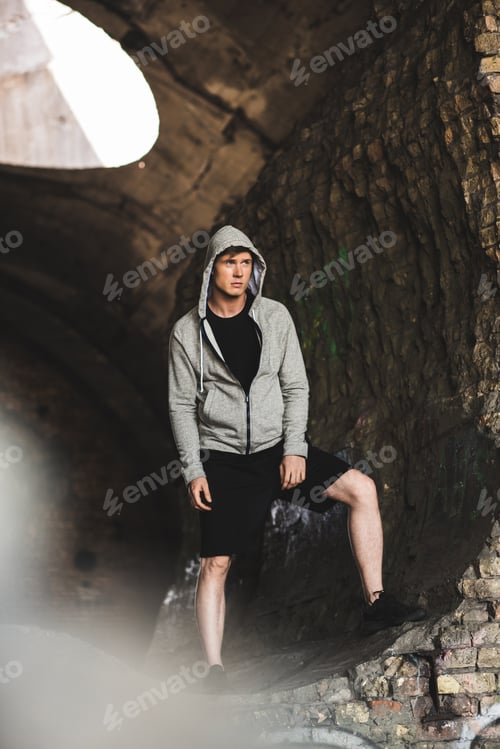 Preview: pensive young man in hoodie looking away
