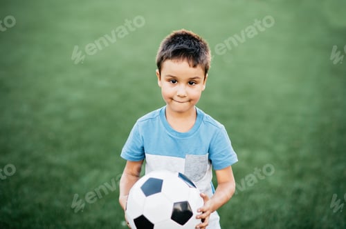 Preview: portrait of happy boy lying on football field