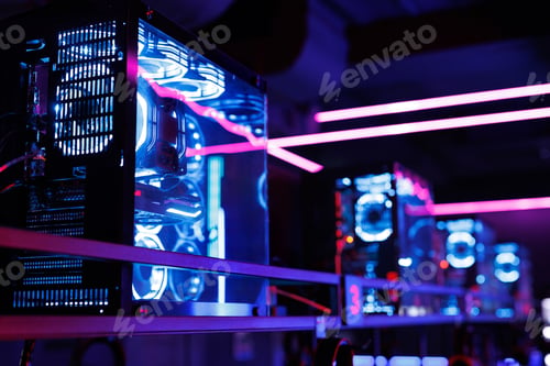 Preview: Professional gaming computer with neon backlight with headset in the computer club for gamers.
