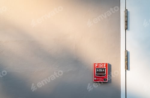 Preview: Fire alarm on dark gray concrete wall. Warning and security system. Emergency equipment for safety