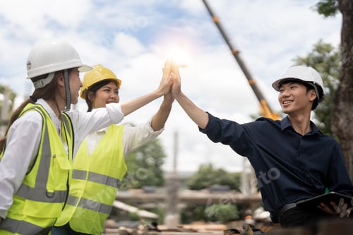 Preview: Engineers people join hands to build successful projects. Teamwork concept.