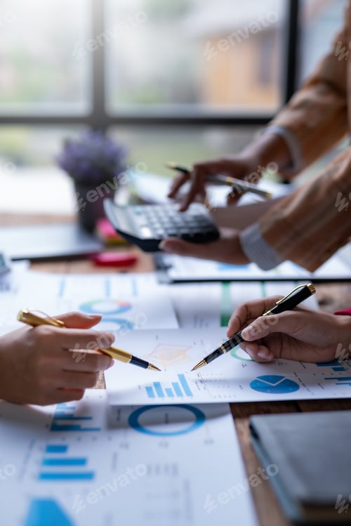 Preview: Business Professionals Analyzing Charts and Graphs in Office