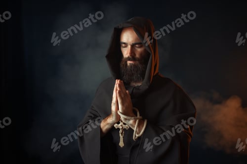Preview: Medieval monk praying with closed eyes