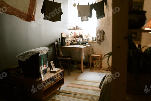 Preview: Cozy Domestic Interior Featuring Laundry Drying in Sunlit Small Apartment