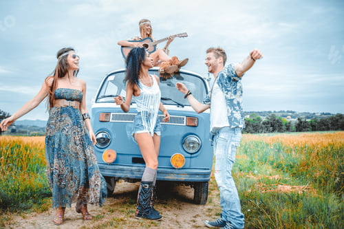 Preview: Happy friends driving a vintage minivan